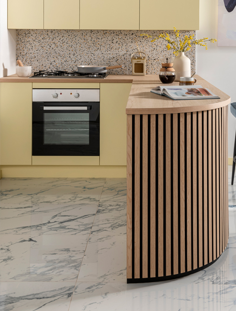 Kitchen tiles that have a marble effect, with a breakfast bar and an oven in the background