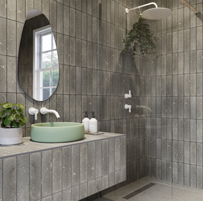 Shower room with vertical grey tiles and a pear shaped mirror